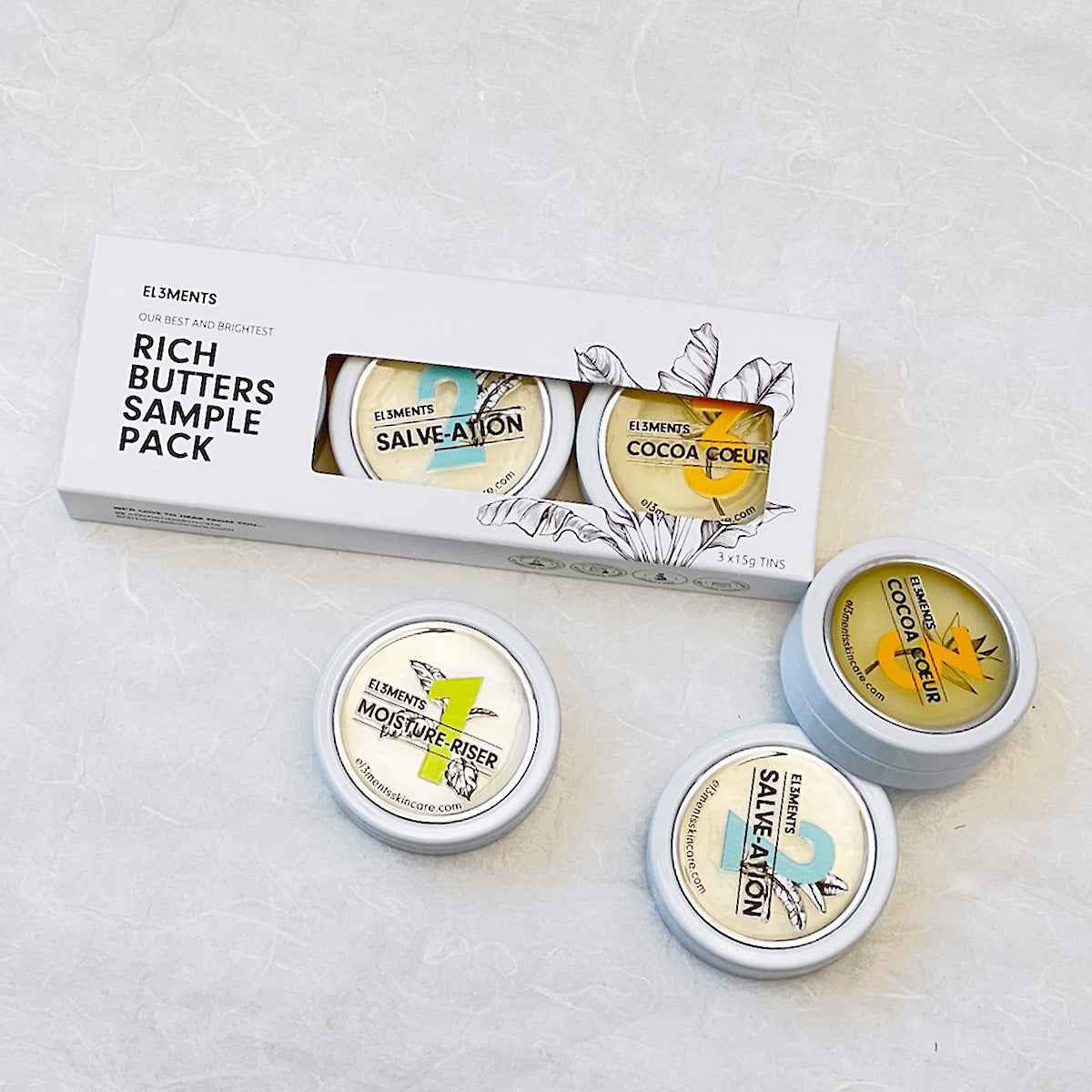 El3ments Rich Butters Sample Pack with additional aluminum tins on a textured white background