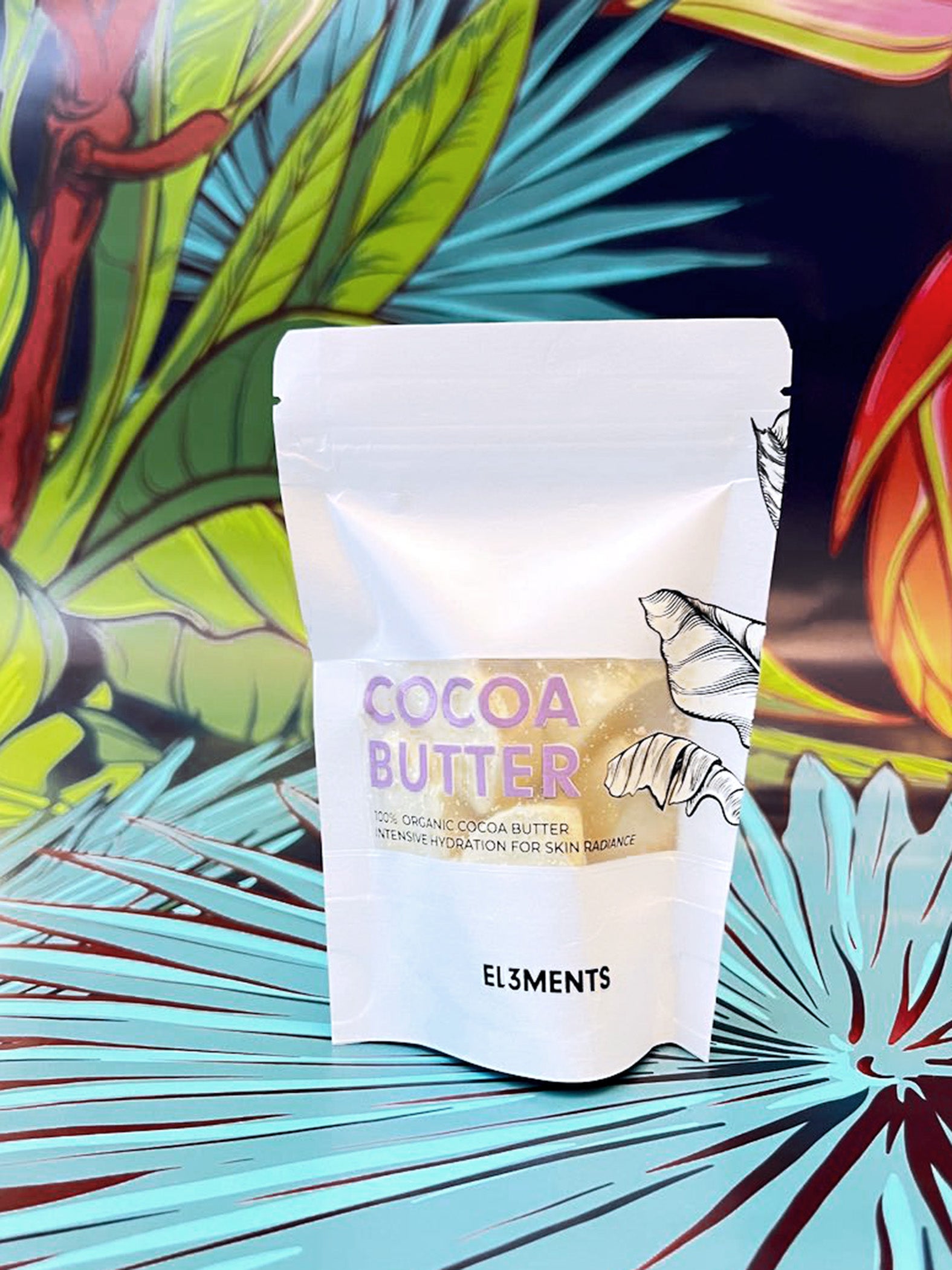 Package of cocoa butter with El3ments branding against a colorful leafy background