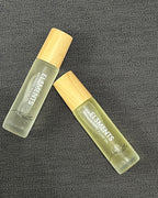 Two small fragrance oil bottles labeled El3ments on a textured gray background
