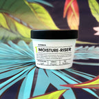 MOISTURE-RISER Body Butter demi jar on tropical background