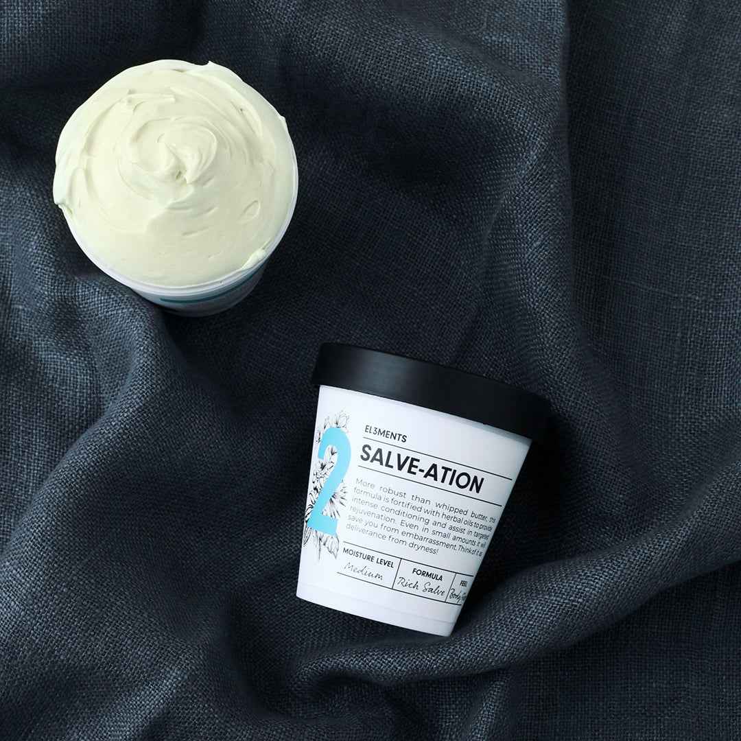 Salve-ation Body Butter jars open showing texture on grey linen background