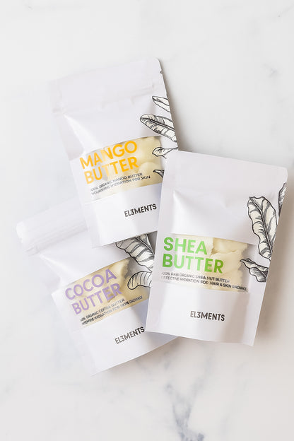 Shea butter, mango butter, cocoa butter packages on a white marble surface