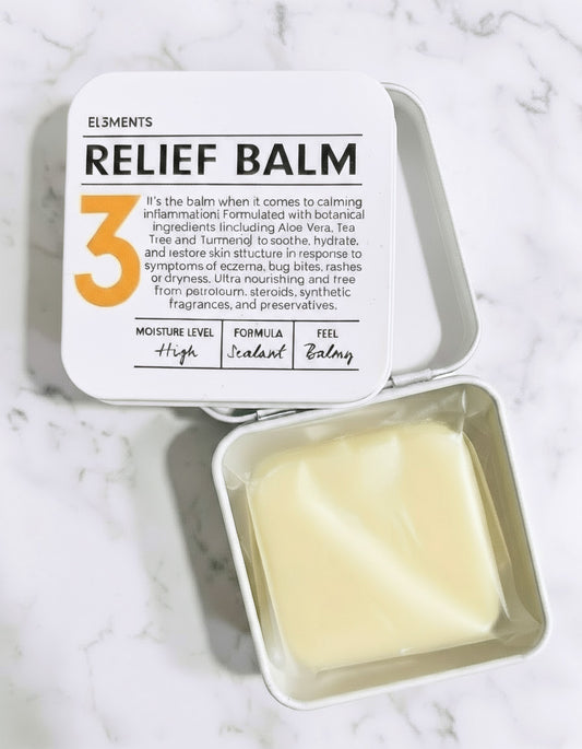 Relief balm in a tin with a white label on a marble surface