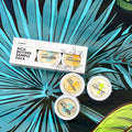 El3ments Rich Butters Sample Pack with additional aluminum tins  on a tropical background